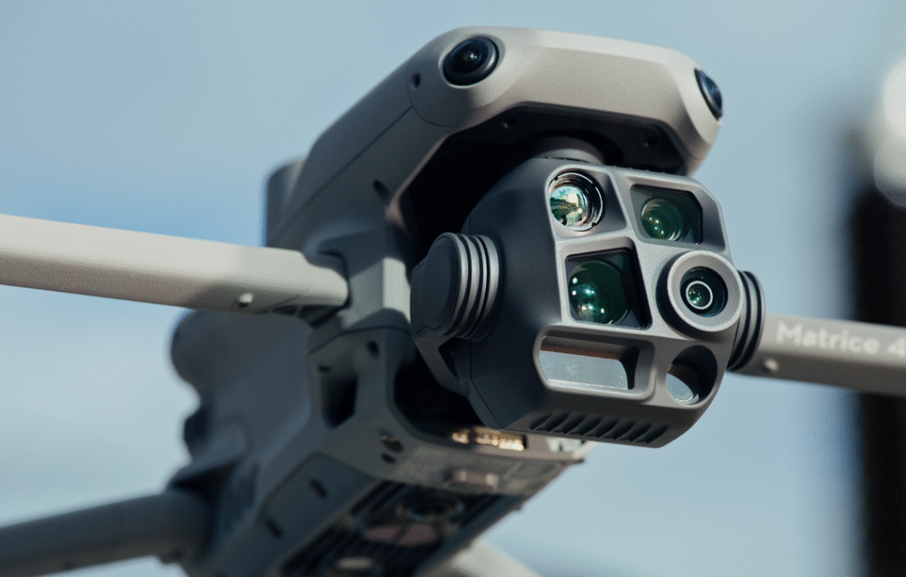 DJI Matrice 4T drone flying over an industrial site, showcasing advanced multi-sensor payloads.