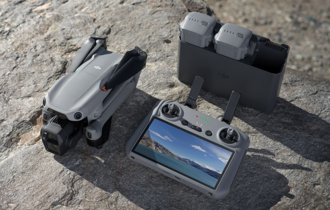 DJI Air 3S Fly More Combo drone with DJI RC 2 remote, batteries, and accessories neatly arranged on a table.